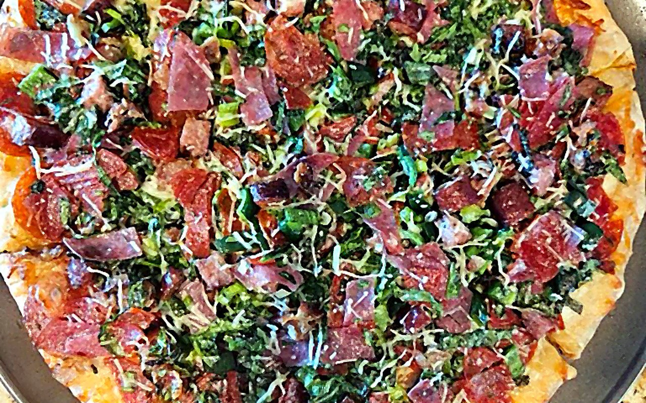 Pizza with greens and pepperoni